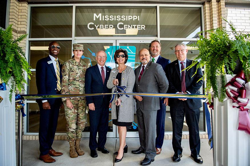 Officials cut a ribbon in front of the Mississippi Cyber Center