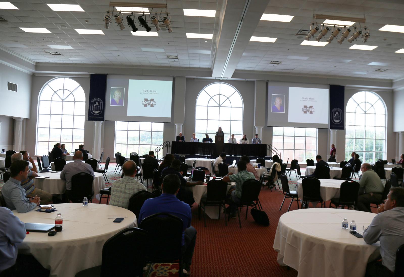 A room of people gathered at Mississippi College listening to a panel